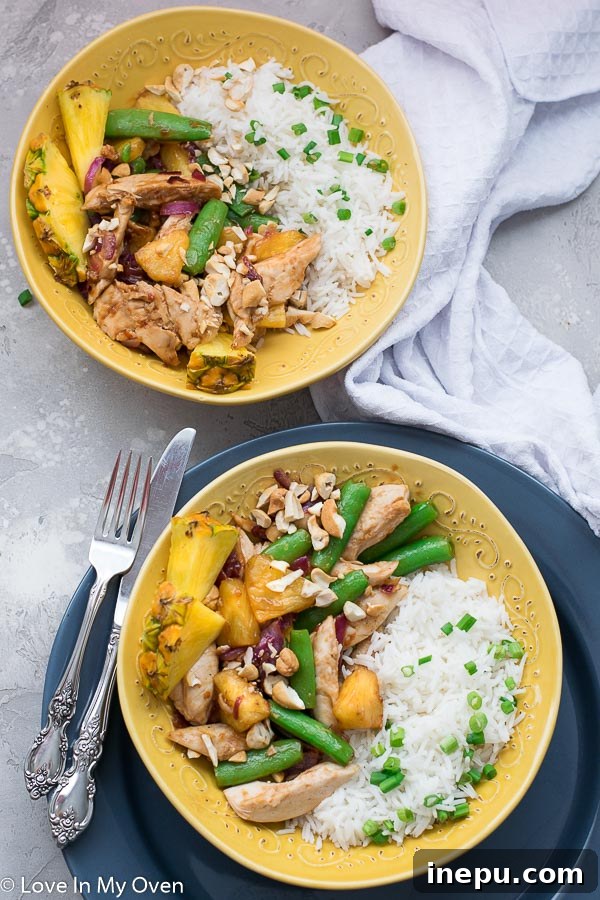 Golden Pineapple Chicken Stir-Fry 8 Overhead shot of chicken and pineapple stir fry with rice, highlighting vibrant colors and fresh ingredients.