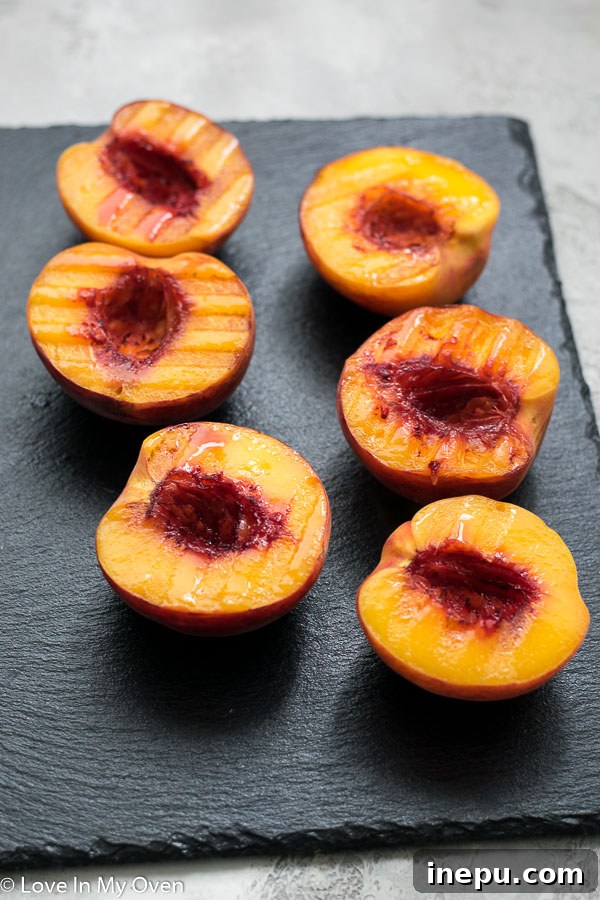 Halved peaches grilling on a barbecue