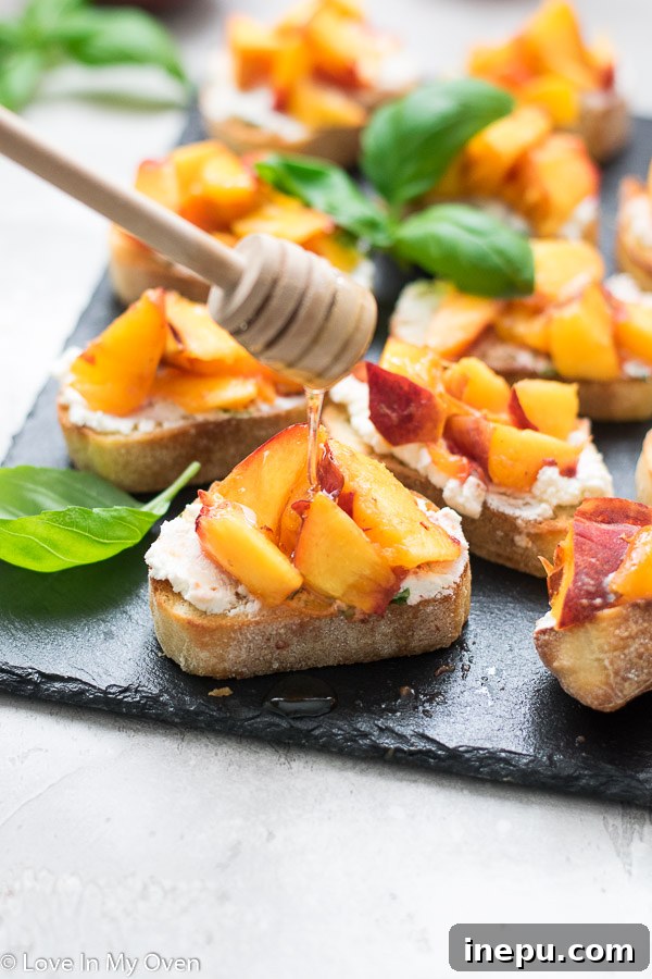 Finished grilled peach crostini with honey drizzle on a platter