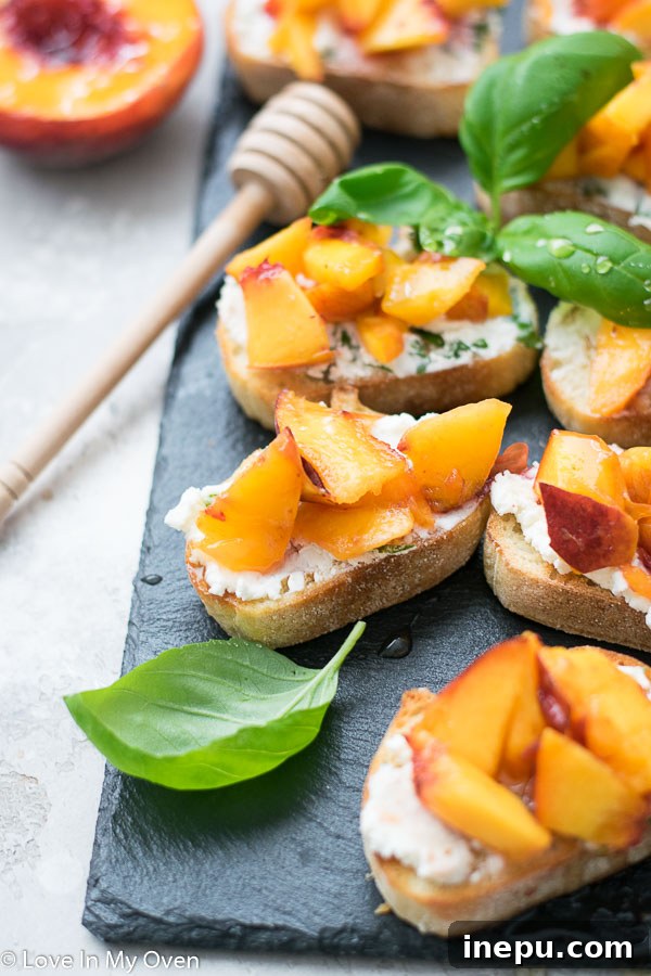 Artfully arranged grilled peach crostini with fresh basil garnish