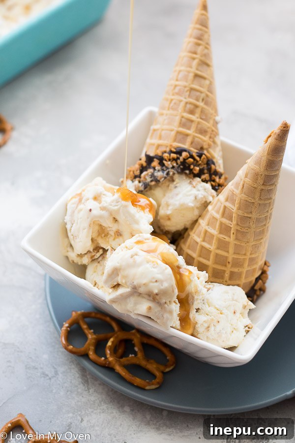 Salted caramel pretzel ice cream in a serving bowl with a spoon