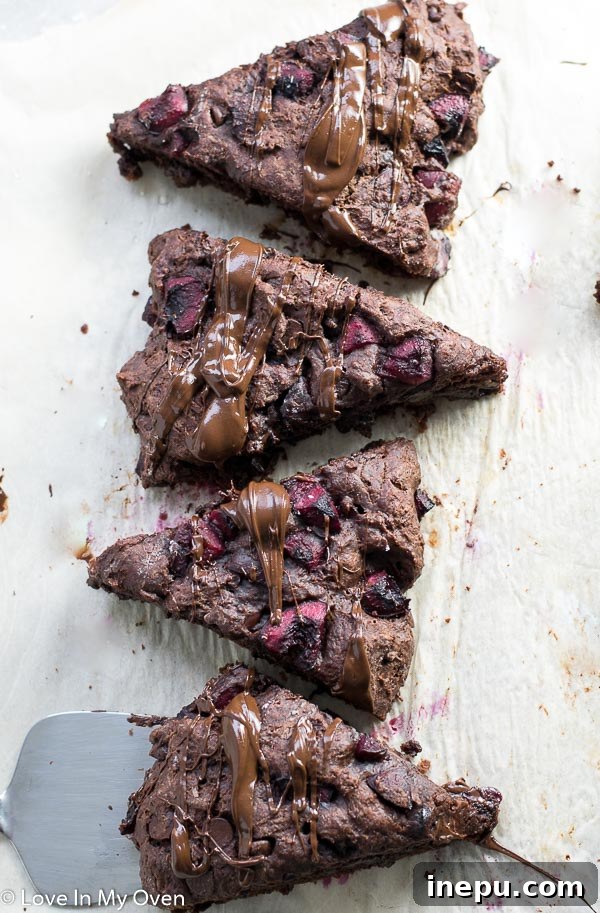 Decadent Chocolate Cherry Scones 7 A stack of chocolate cherry scones showing flaky texture and juicy cherries