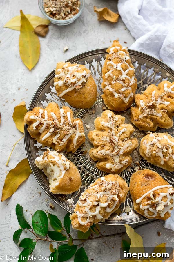 Petite Maple Pecan Treasures 3 A close-up shot of mini maple pecan bundt cakes with a delicate frosting drizzle