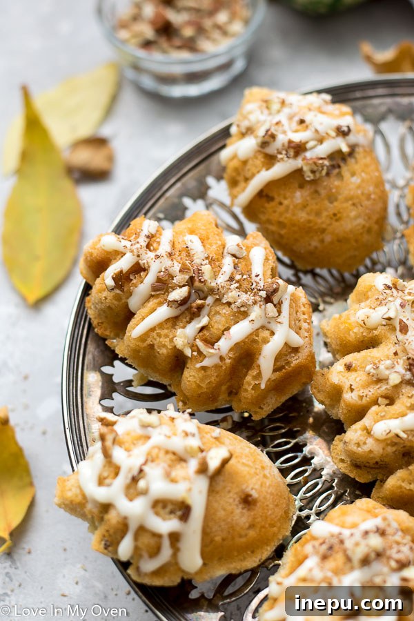 Petite Maple Pecan Treasures 7 Multiple mini maple pecan cakes on a cooling rack, some with frosting