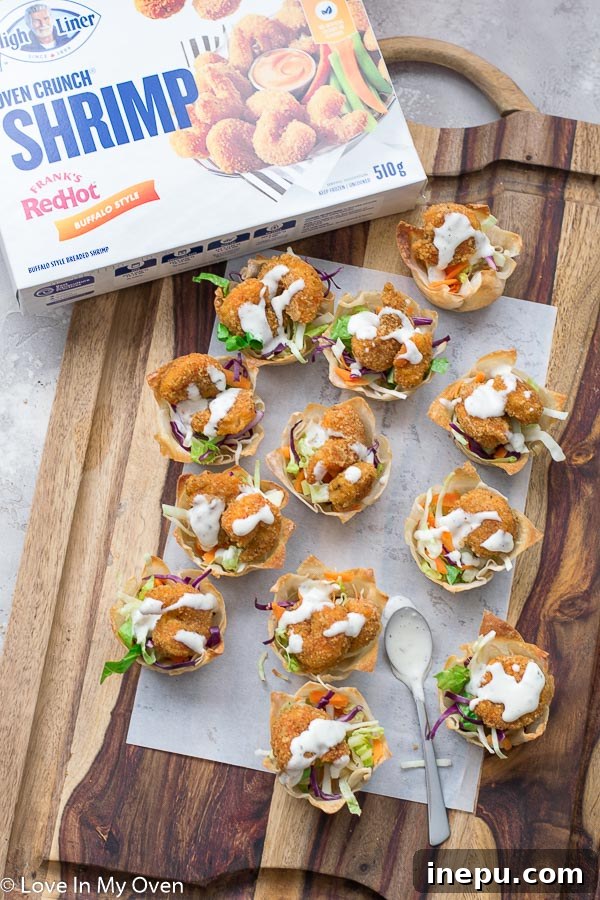Crispy Buffalo Shrimp Wonton Cups ready to serve, arranged beautifully on a platter for a party appetizer.
