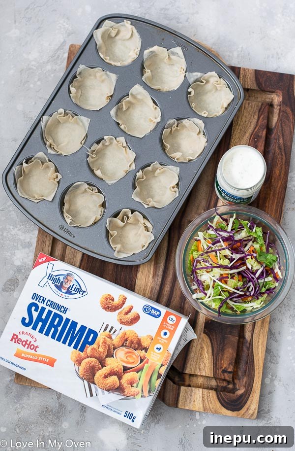Hands preparing wonton wrappers in a muffin tin, brushing them with olive oil before baking.