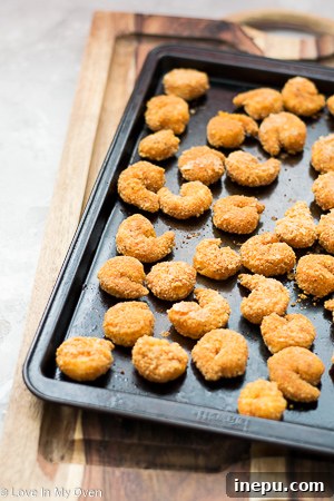 Another angle of the vegetable mixture being added to crispy wonton cups.