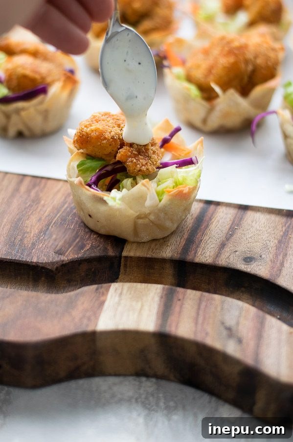 Freshly baked crispy wonton cups filled with colorful shredded vegetables.