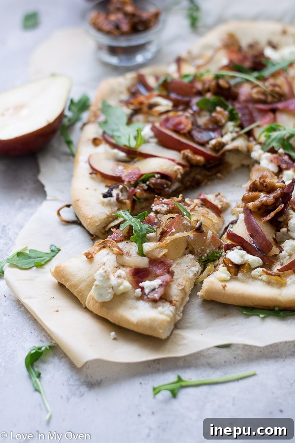 Sweet Pear and Tangy Goat Cheese Pizza 9 Hand holding a slice of Pear and Goat Cheese Pizza