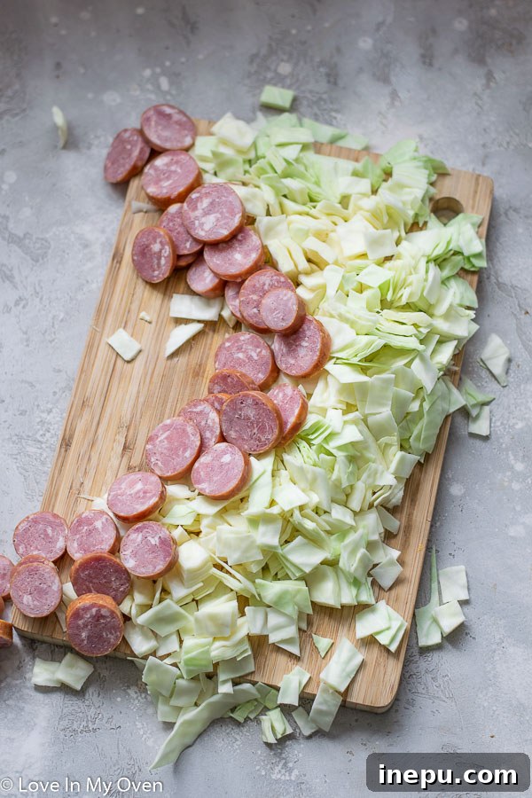Sausage and Cabbage Skillet cooking in a cast iron pan