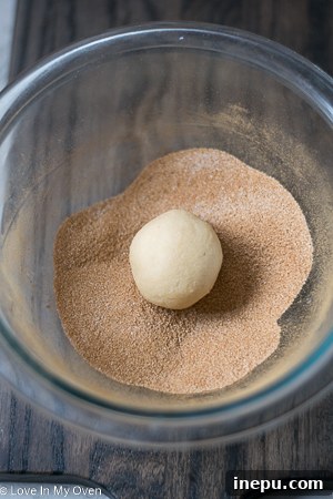 Cookie dough balls chilling on a parchment-lined baking sheet