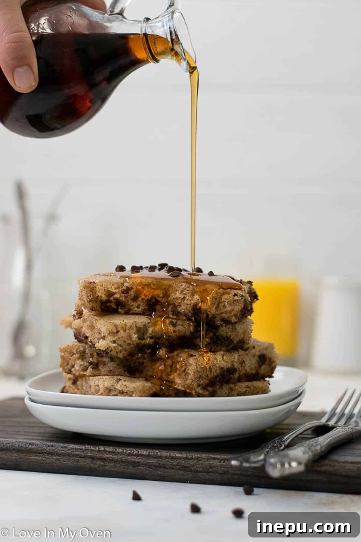 Stack of chocolate chip baked pancakes drizzled with syrup