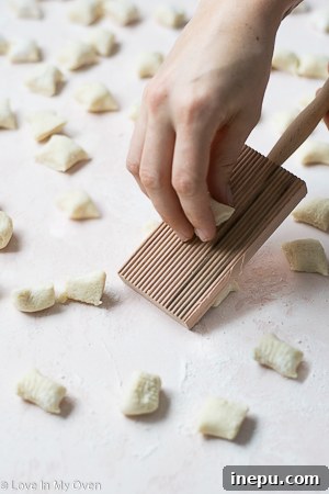 Pillowy Homemade Cauliflower Gnocchi 9 Shaping cauliflower gnocchi with a fork