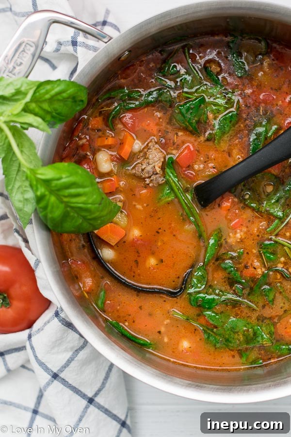 Close-up of creamy sausage gnocchi soup with spinach