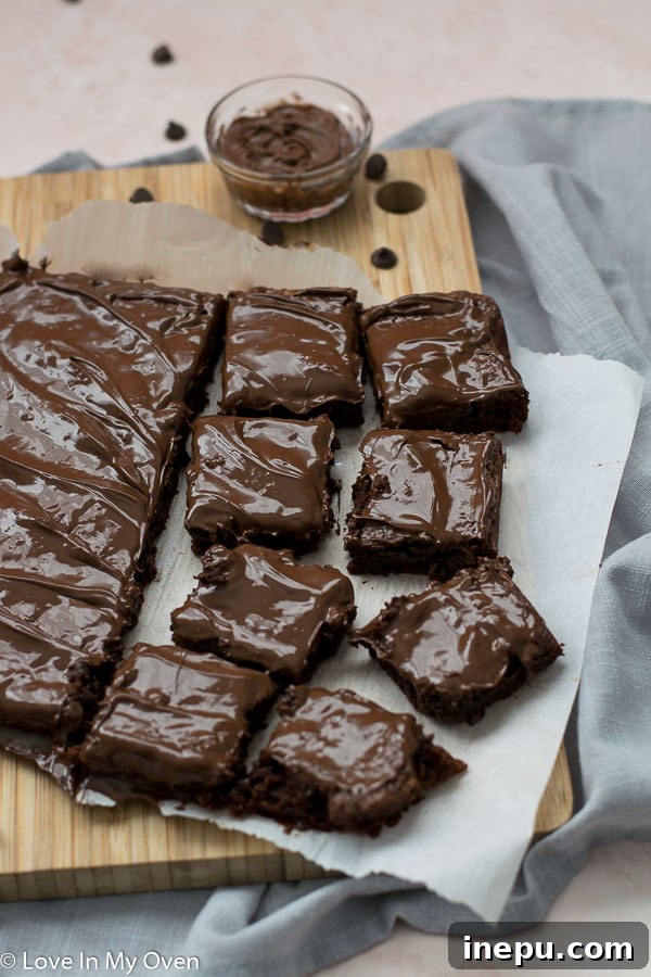 Effortless 3-Ingredient Nutella Brownies 3 Close-up of baked 3-ingredient Nutella brownies in a pan before cutting, showcasing their rich, dark color.