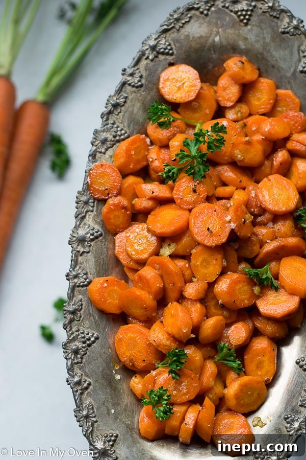 Serving of garlic butter roasted carrots in a white bowl