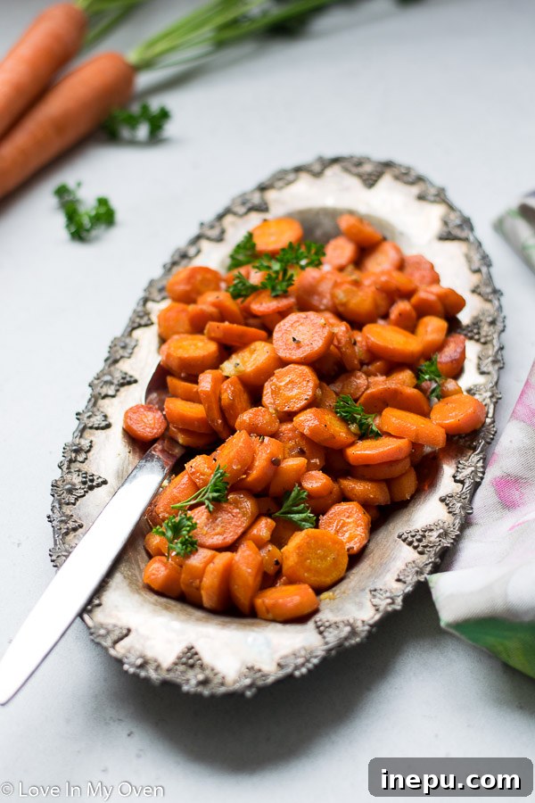 Close-up of garlic butter roasted carrots garnished with fresh herbs