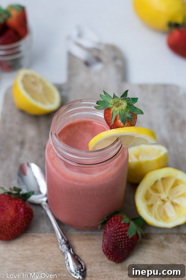 Luscious Strawberry Lemon Curd 7 Two jars of homemade strawberry lemon curd with spoons, ready for use.