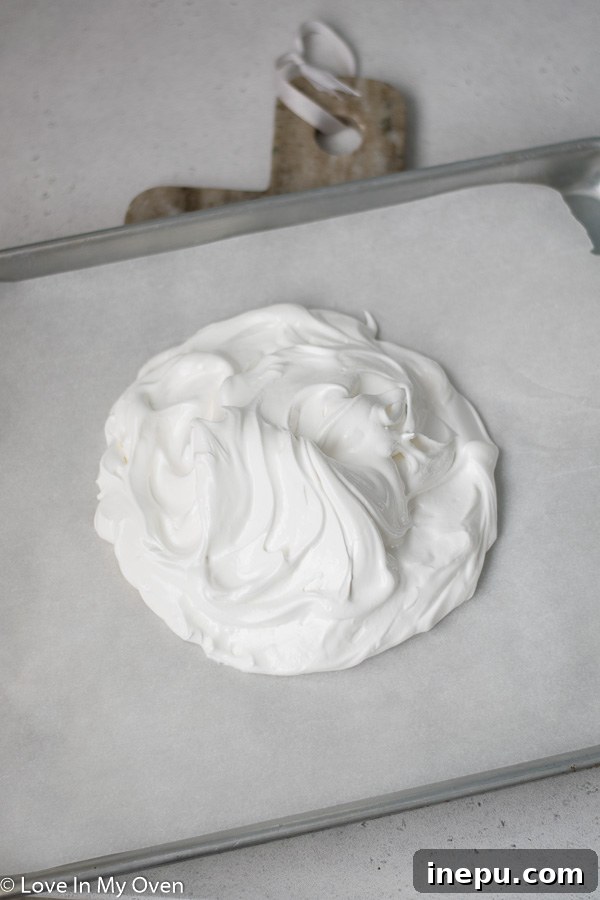Pavlova shaped on baking sheet