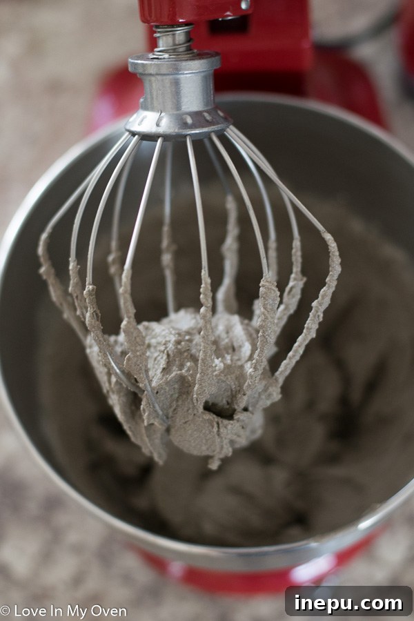Close-up of mint Oreo mousse being whipped in a stand mixer