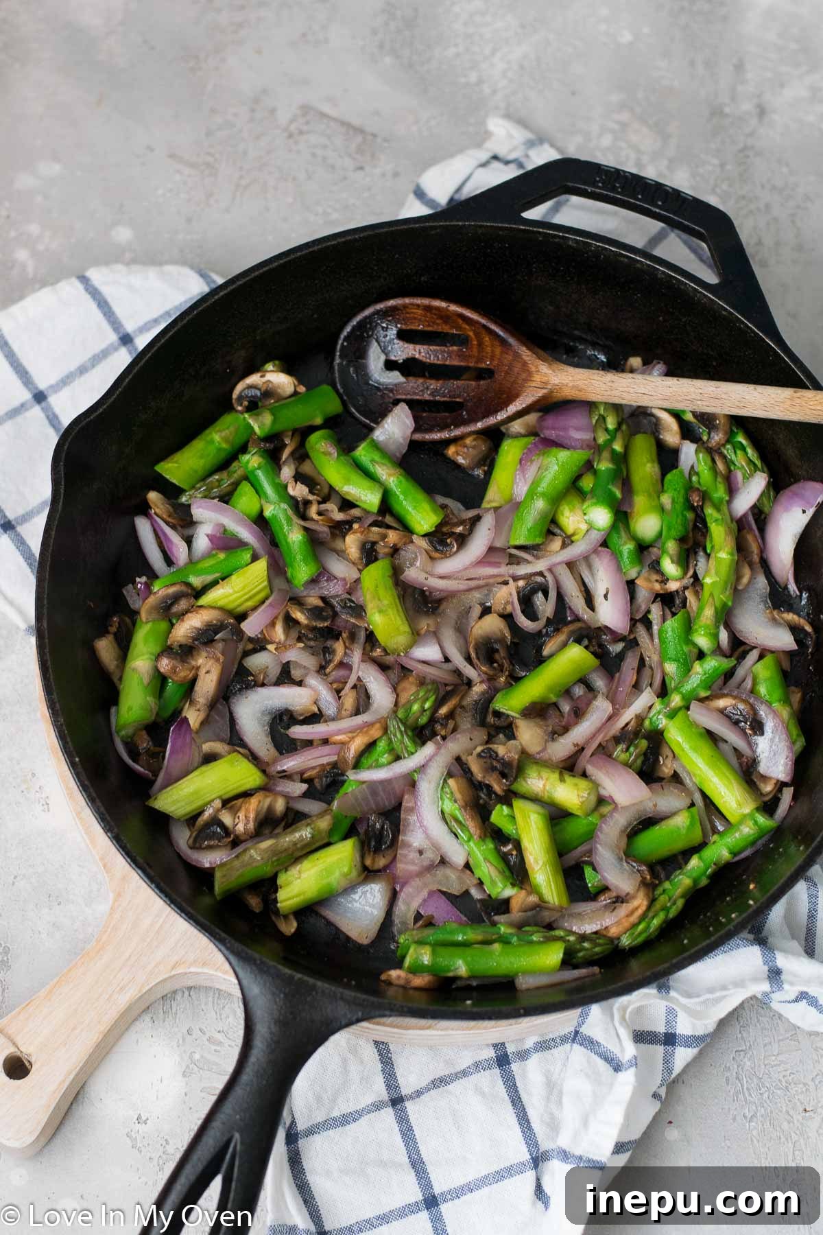 Springtime Carbonara with Asparagus and Peas 5 Spaghetti carbonara with peas and asparagus being mixed in a large skillet