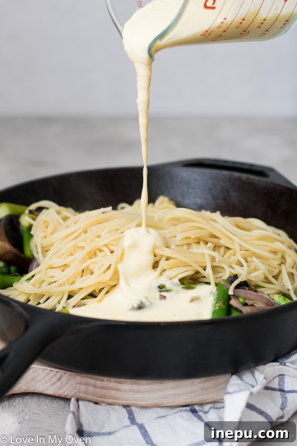 Springtime Carbonara with Asparagus and Peas 6 Finished spaghetti carbonara with crispy bacon and fresh parmesan cheese on top