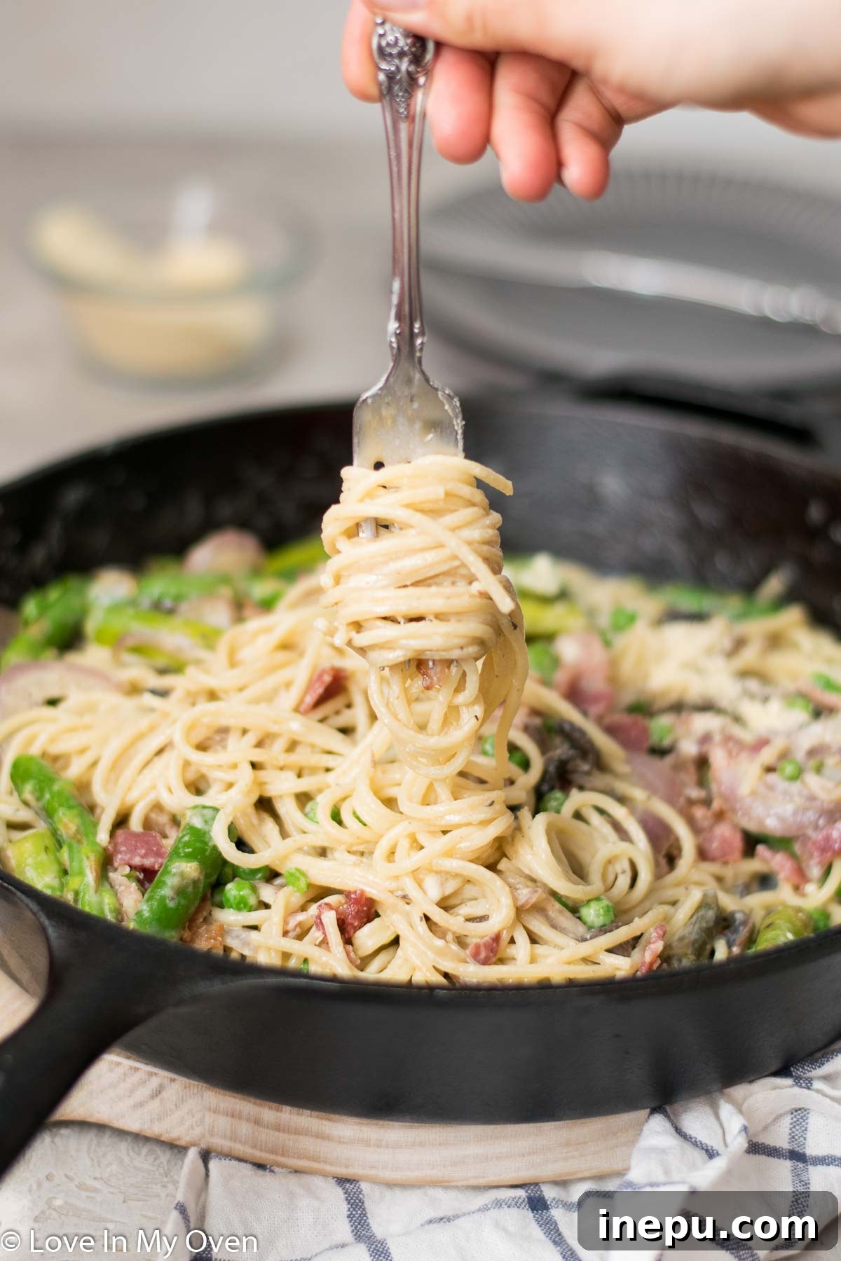 Springtime Carbonara with Asparagus and Peas 7 Full plate of spaghetti carbonara with peas and asparagus, garnished with fresh herbs