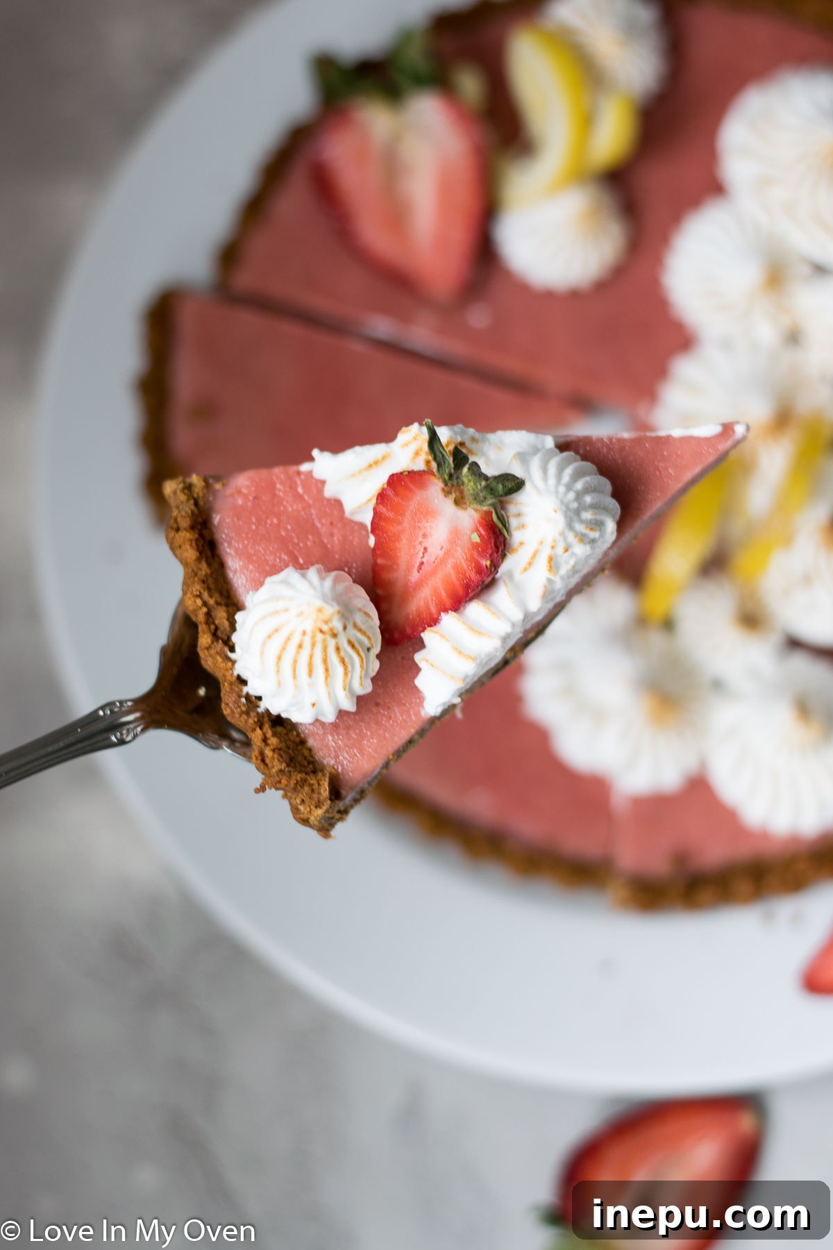 Close-up of a Single Slice of Strawberry Lemon Curd Tart with Meringue on a Plate