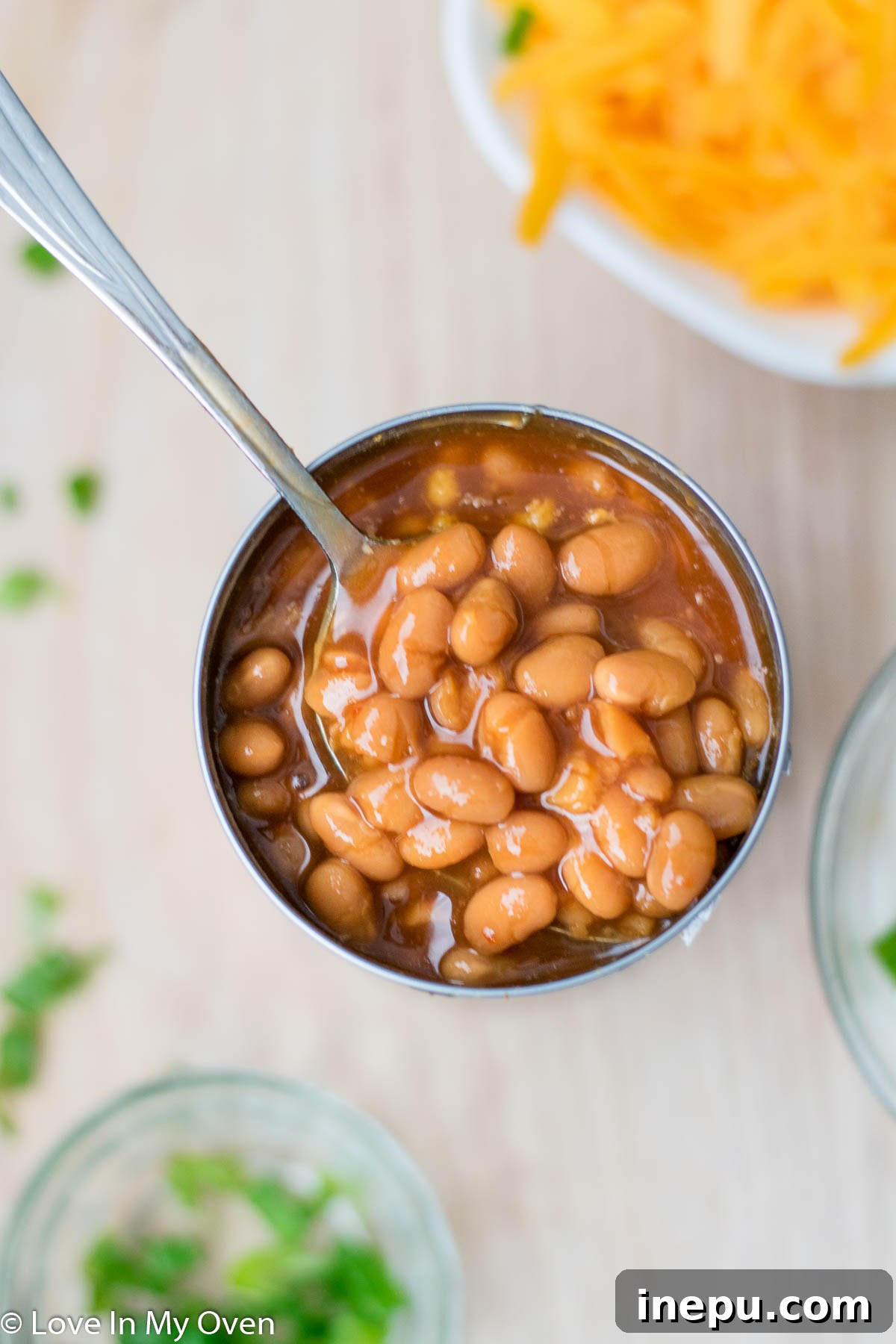 Bush's Homestyle Baked Beans spread over skillet fries, topped with cheese