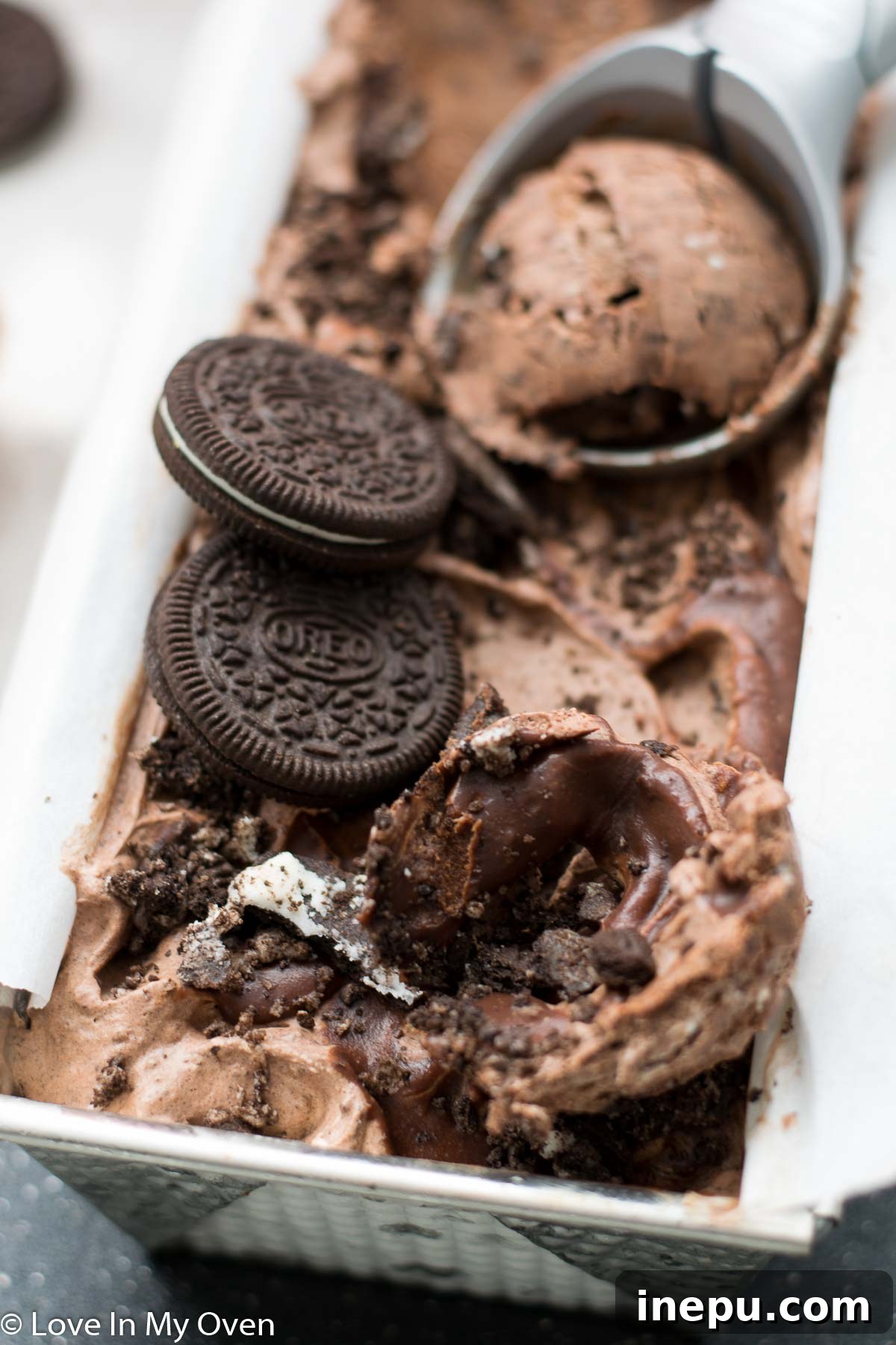 Decadent No-Churn Chocolate Oreo Delight 4 Scoops of No-Churn Chocolate Oreo Ice Cream in a bowl, showcasing its creamy texture.