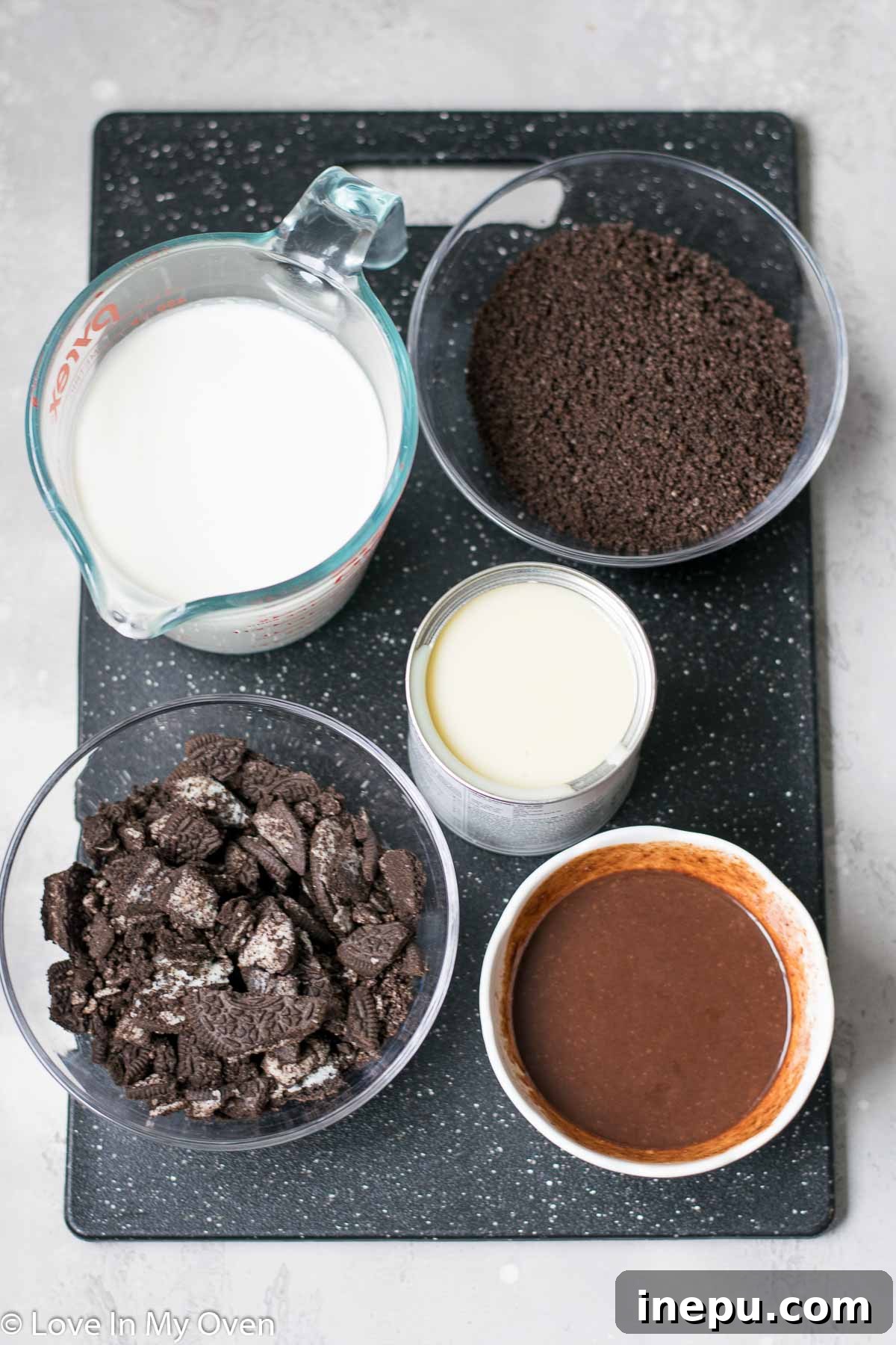 Decadent No-Churn Chocolate Oreo Delight 5 Ingredients for no-churn chocolate Oreo ice cream laid out on a surface.