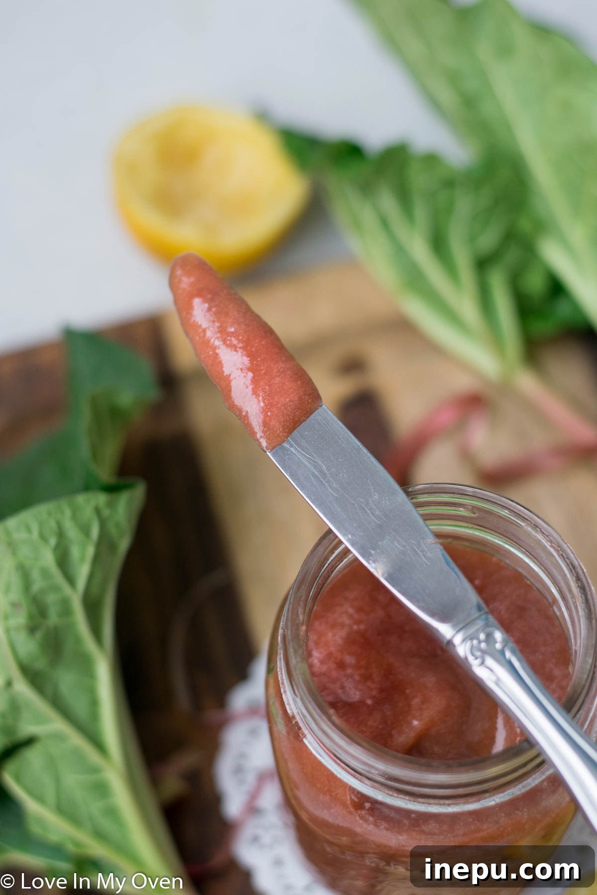 A jar of freshly made rhubarb butter in a rustic setting