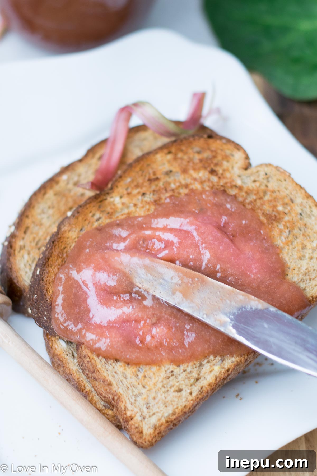 Rhubarb butter generously spread on a piece of toasted bread