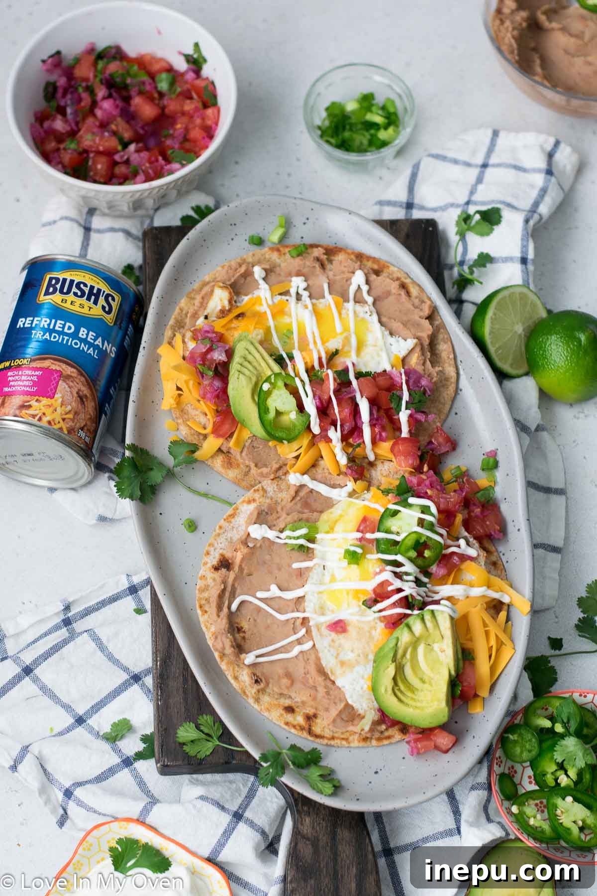 No-Fuss Huevos Rancheros 2 Easy Huevos Rancheros recipe with refried beans, fried egg, avocado, and pico de gallo