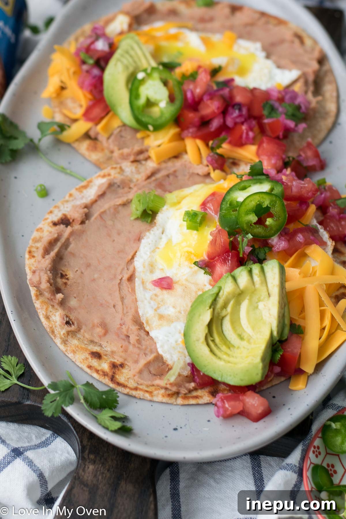 No-Fuss Huevos Rancheros 3 Close-up of easy huevos rancheros with a runny yolk and fresh toppings