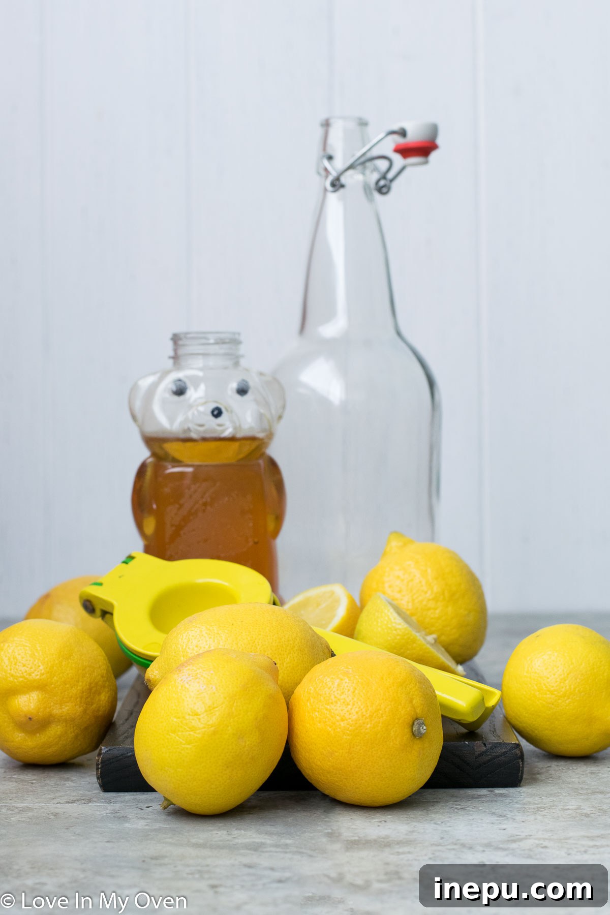 Effortless Honey Lemonade 4 A person squeezing fresh lemon juice into a measuring cup