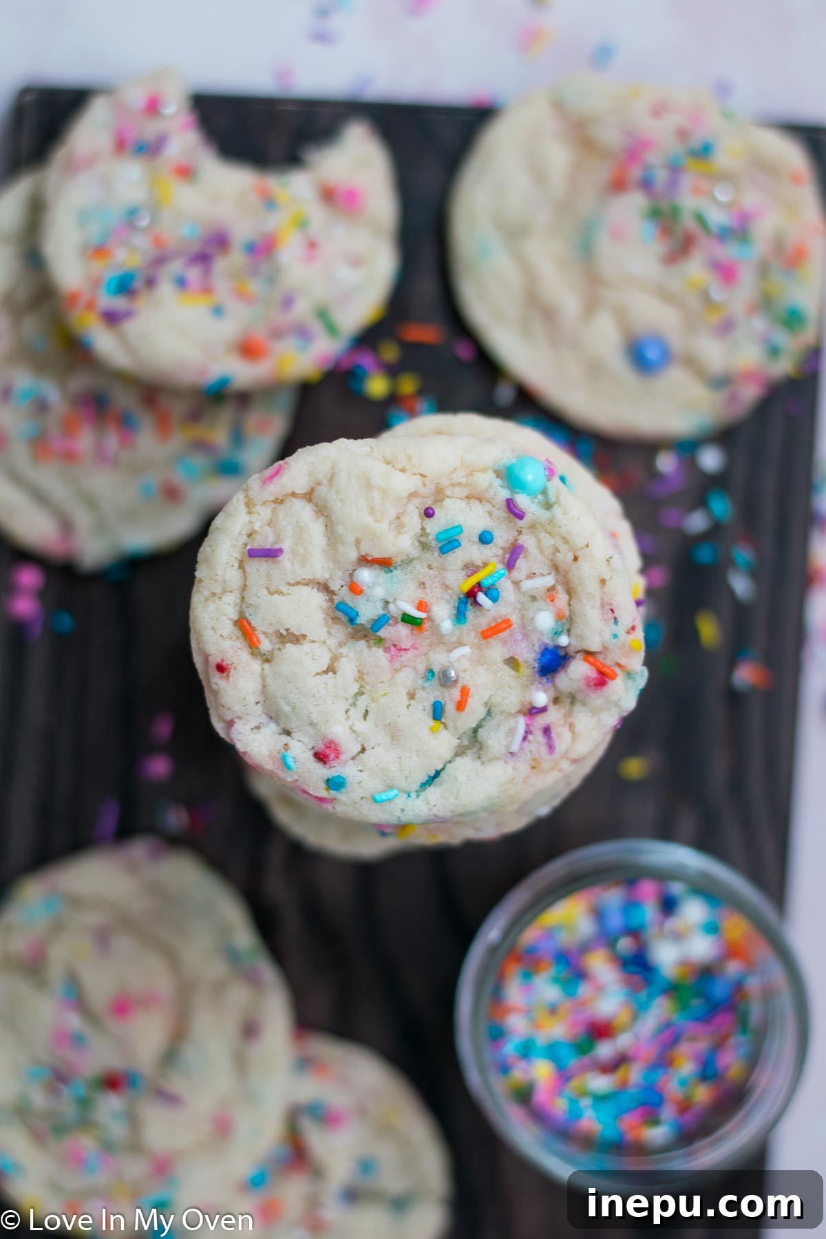 Whimsical Sprinkled Sugar Cookies 3 Close-up shot of a baked sprinkle sugar cookie, highlighting the crisp edges and soft, chewy center with colorful sprinkles.