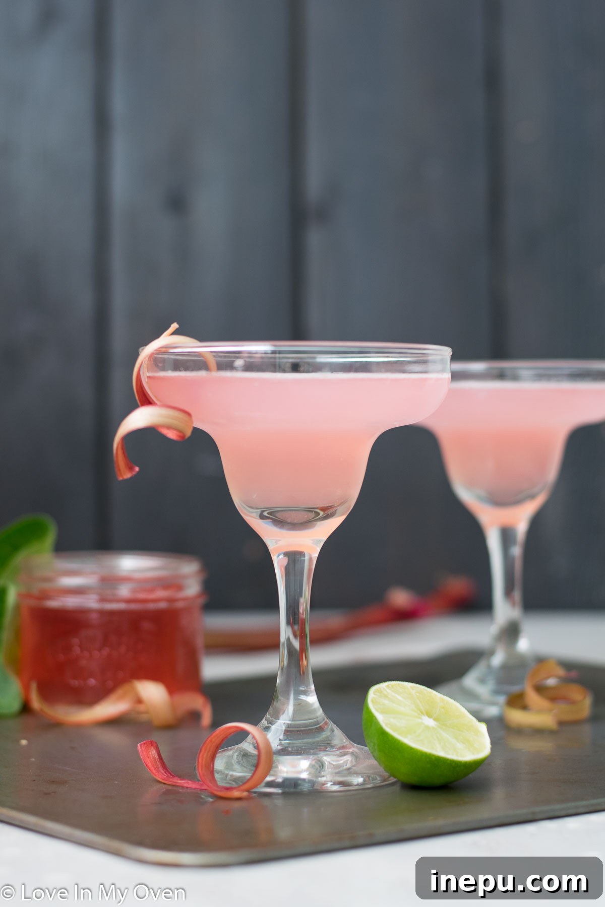 Refreshing Rhubarb Gimlet 6 Two Rhubarb Gimlets with a bottle of gin in the background