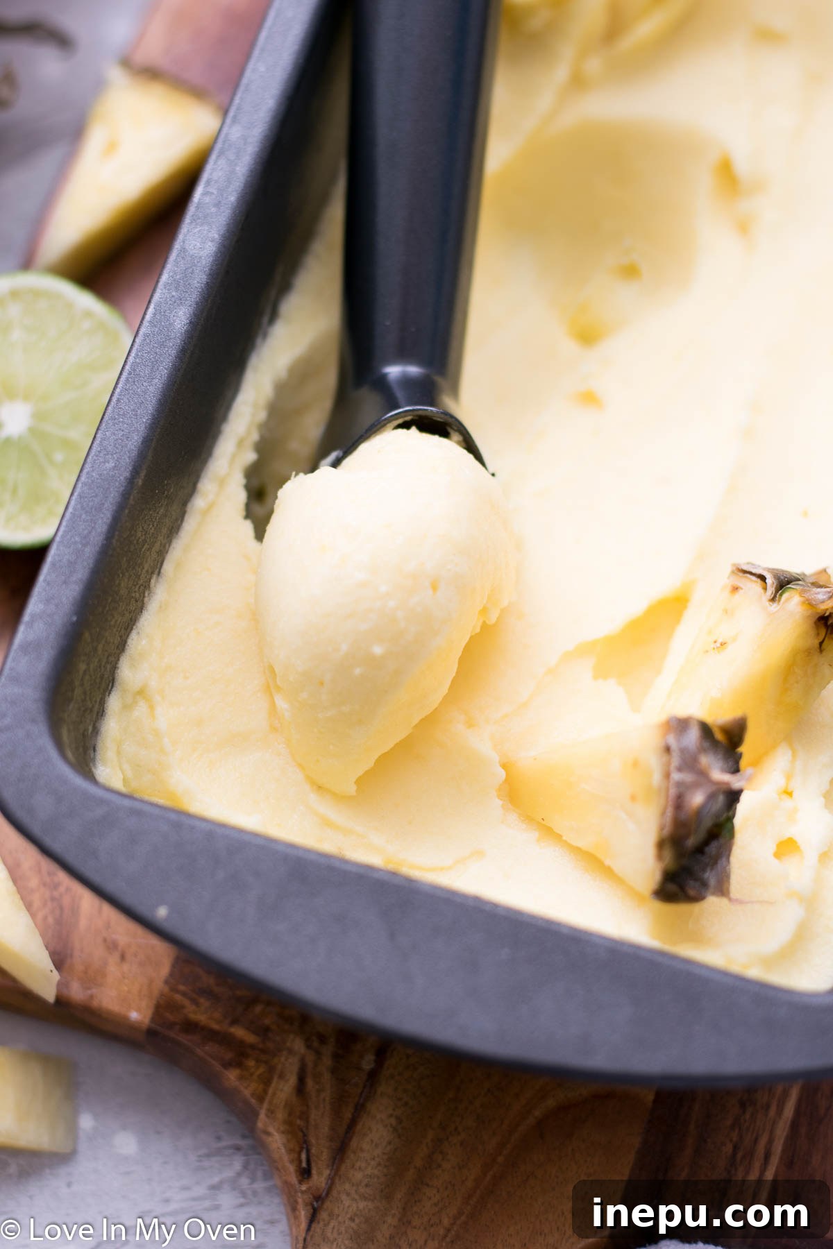 Tropical Pineapple Chill 3 Close-up of golden pineapple sorbet with a spoon, highlighting its creamy texture.