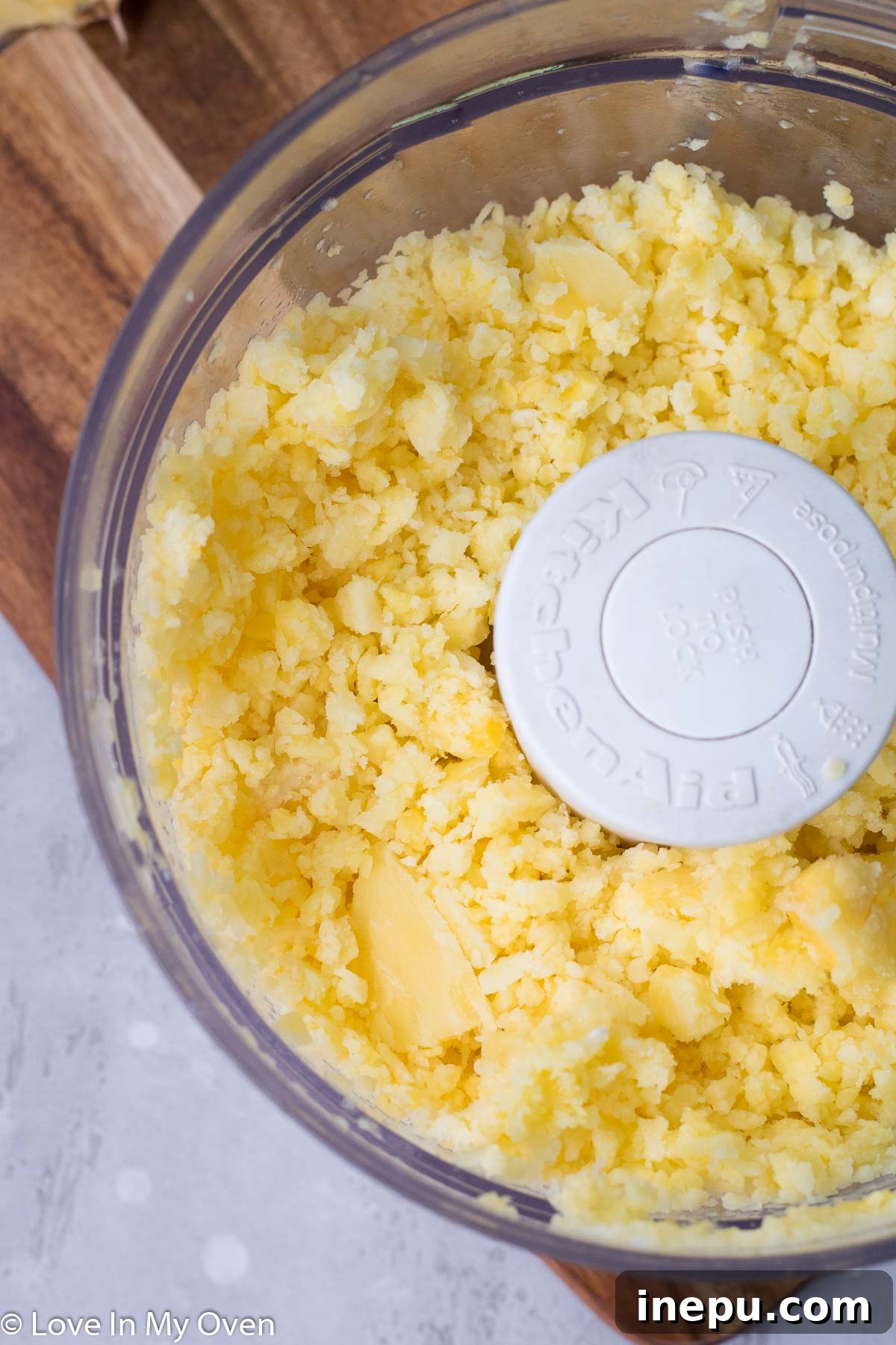 Tropical Pineapple Chill 5 Pineapple chunks blending in a food processor, transforming into a crumbly texture.