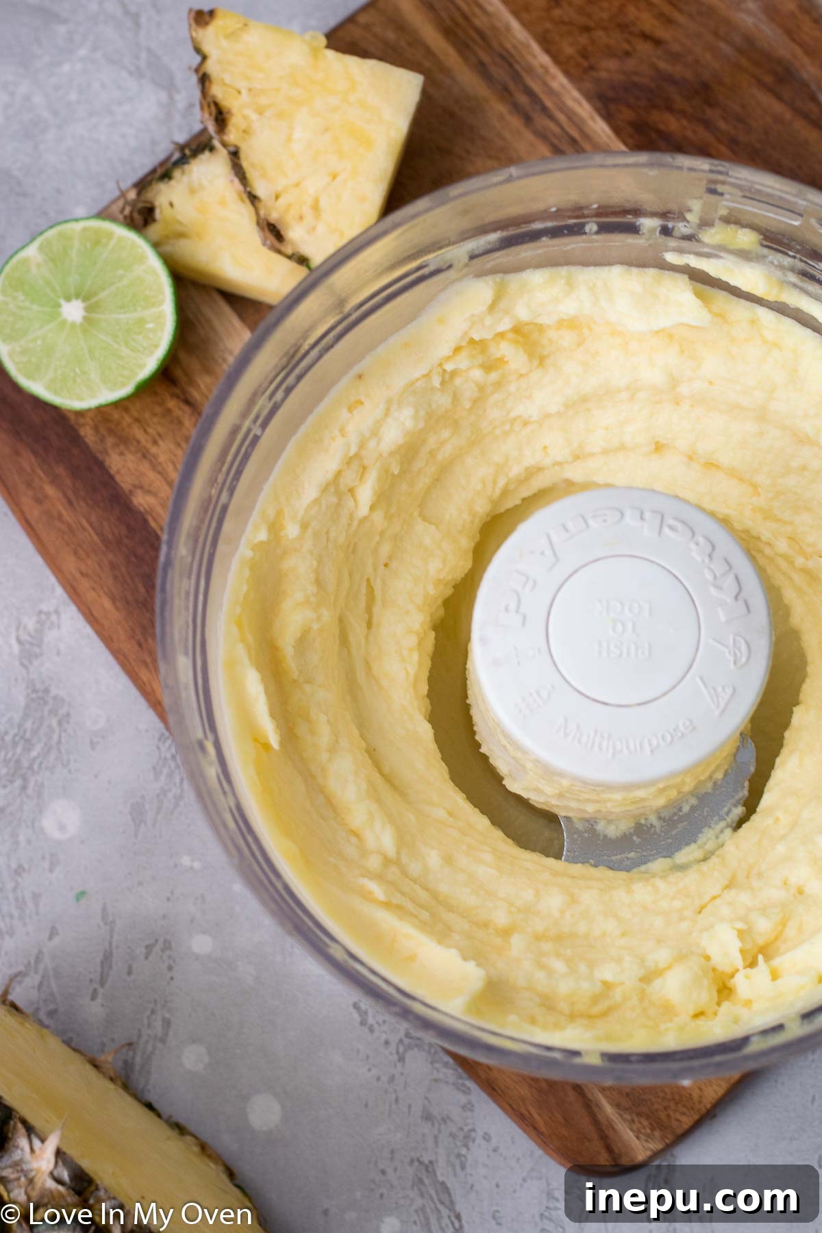Tropical Pineapple Chill 6 Pineapple sorbet blending to a smooth, creamy consistency in a food processor.