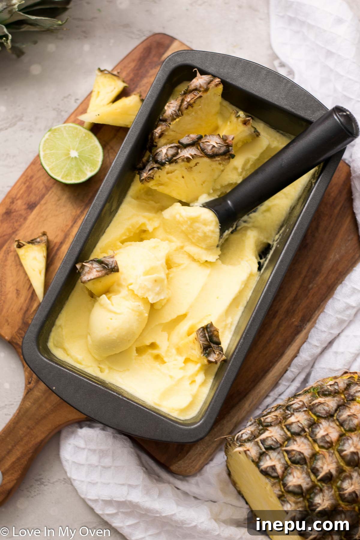 Tropical Pineapple Chill 9 A vibrant bowl of pineapple sorbet with a spoon, highlighting its smooth texture and color.