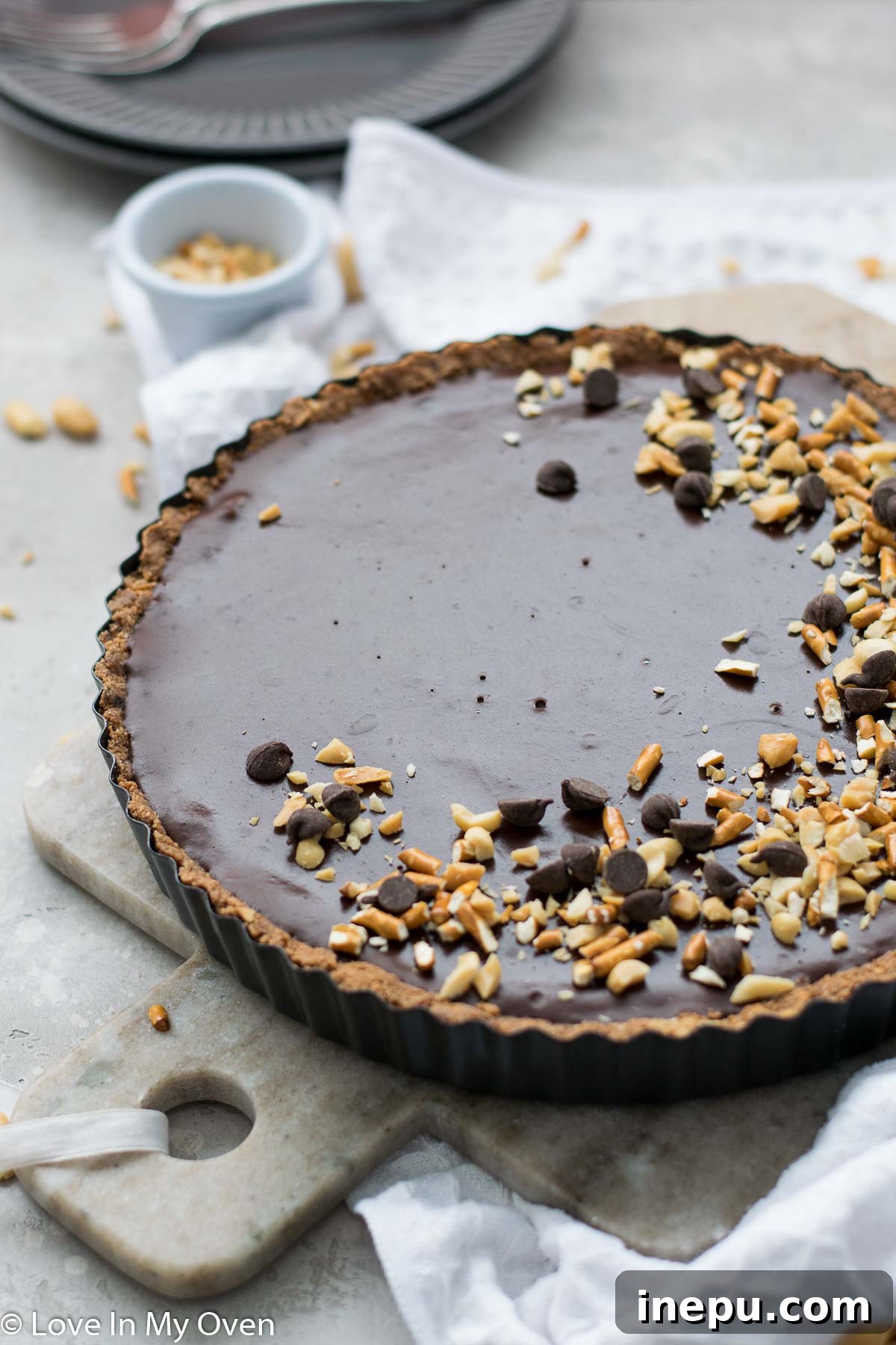 Salted Pretzel Caramel Chocolate Tart 3 Close-up of a slice of Vegan Caramel Chocolate Pretzel Tart showing layers