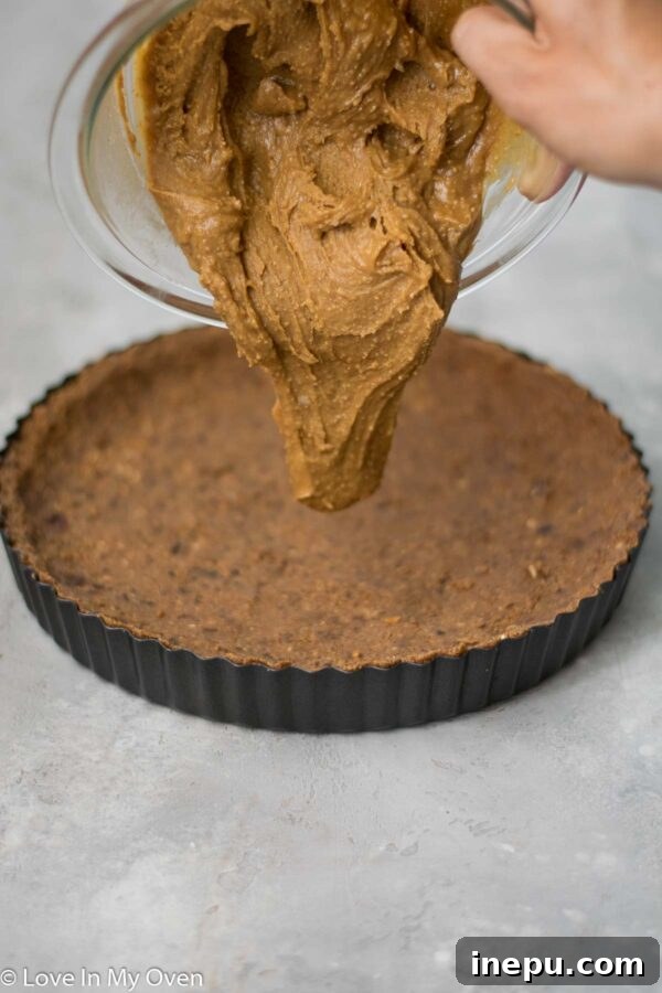 Salted Pretzel Caramel Chocolate Tart 6 Stirring chocolate and coconut milk to make ganache