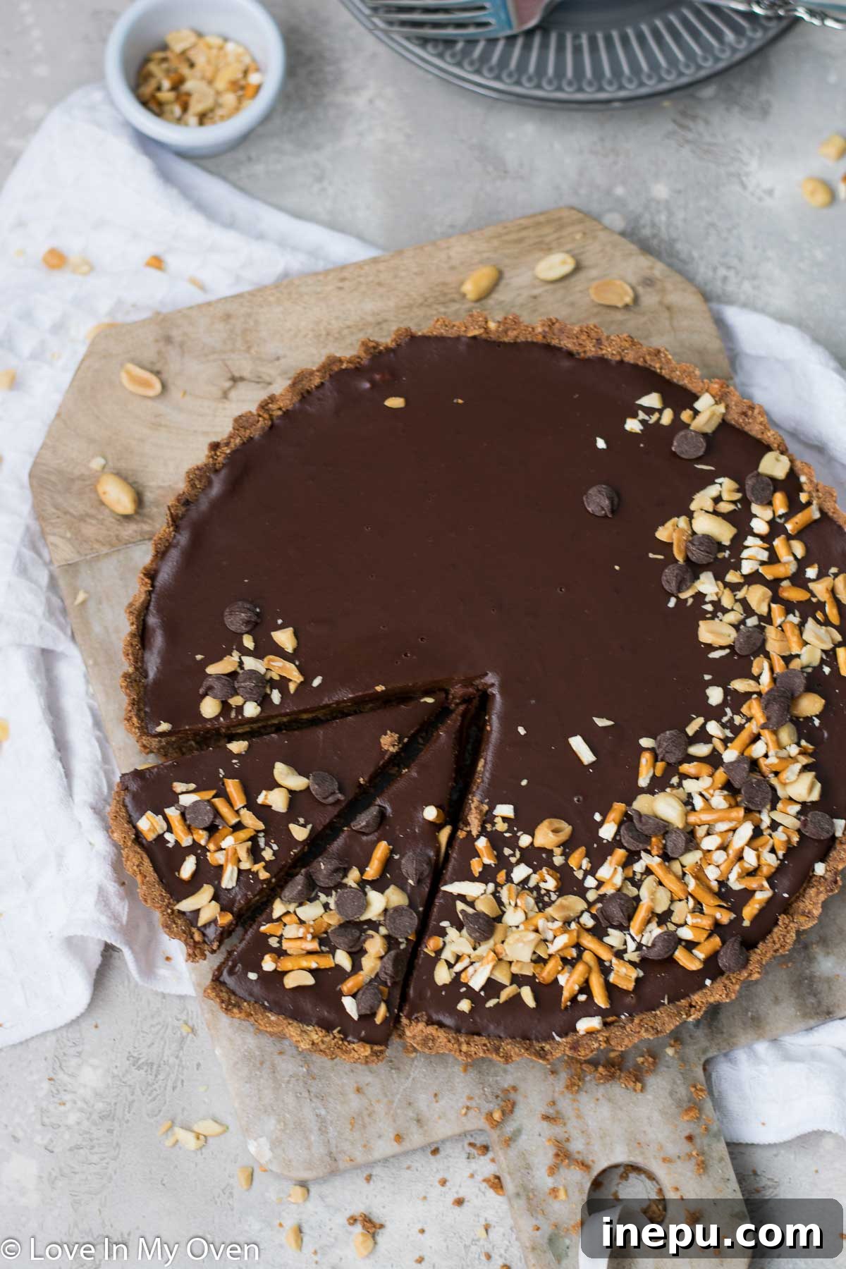 Salted Pretzel Caramel Chocolate Tart 8 A slice of Caramel Chocolate Pretzel Tart with a bite taken out