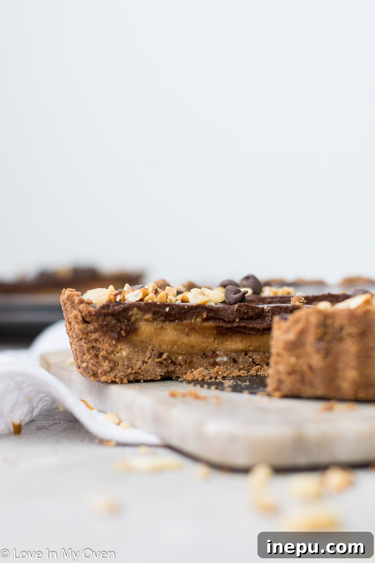 Salted Pretzel Caramel Chocolate Tart 9 Two slices of Vegan Caramel Chocolate Pretzel Tart on a serving plate