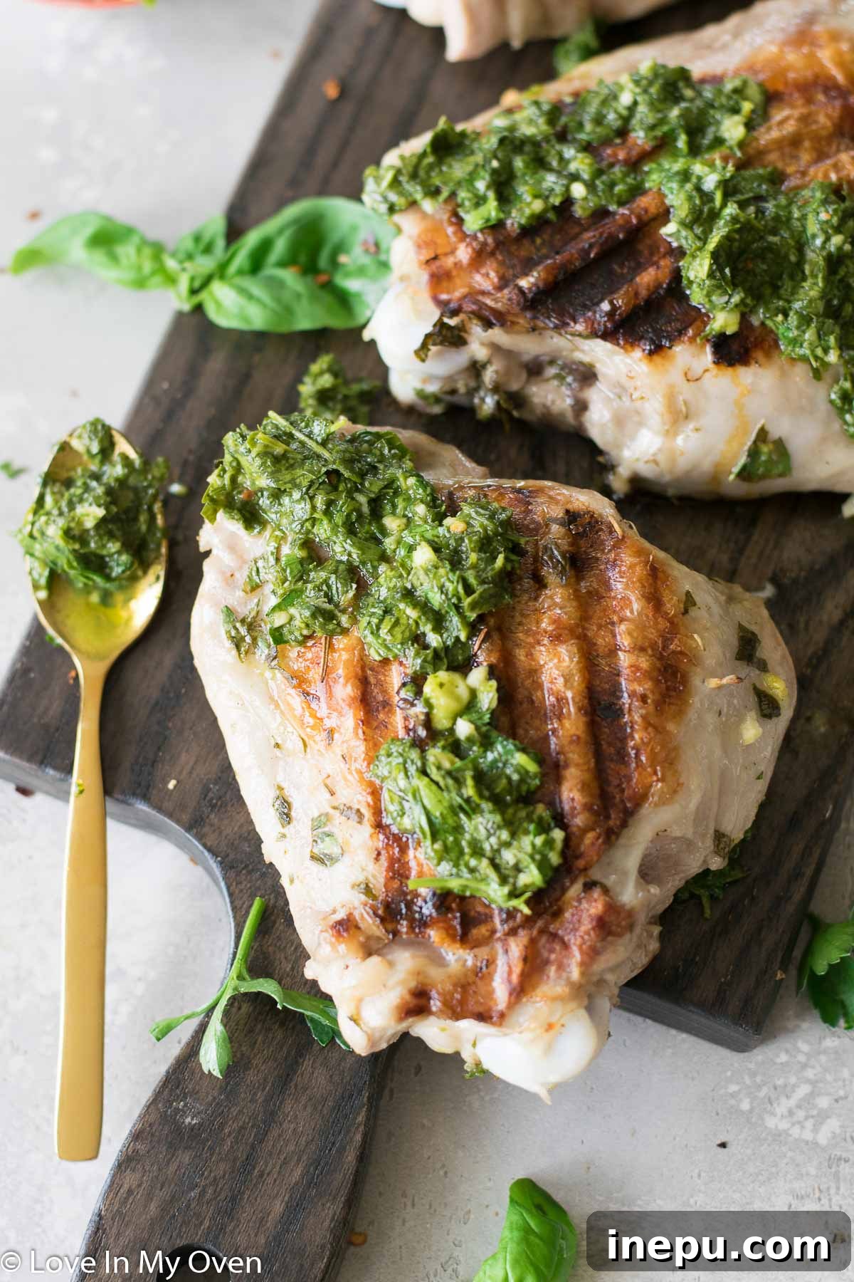 Smoky Turkey Thighs with Vibrant Chimichurri 2 Grilled turkey thighs with vibrant green chimichurri sauce, served on a platter.