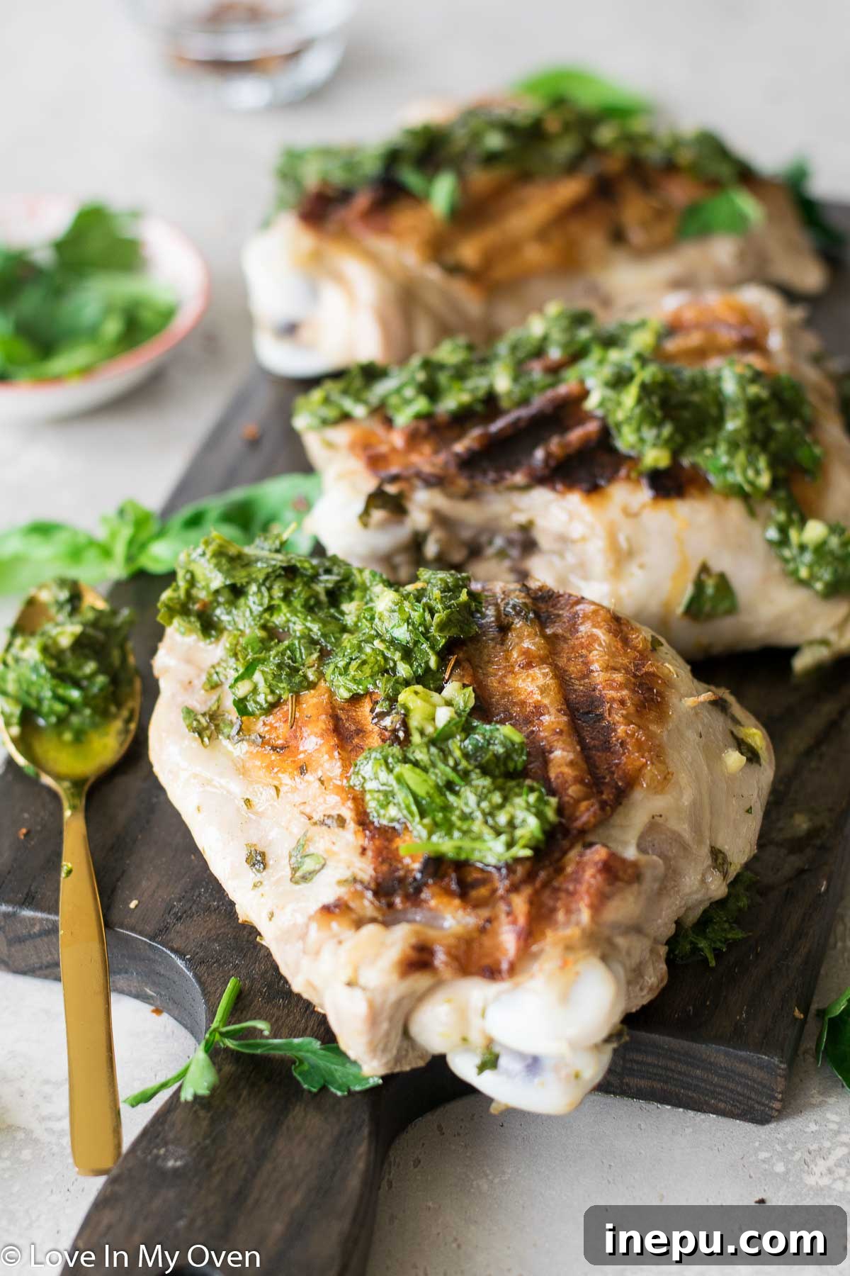 Smoky Turkey Thighs with Vibrant Chimichurri 7 Grilled turkey thighs with chimichurri sauce, plated with roasted baby potatoes.