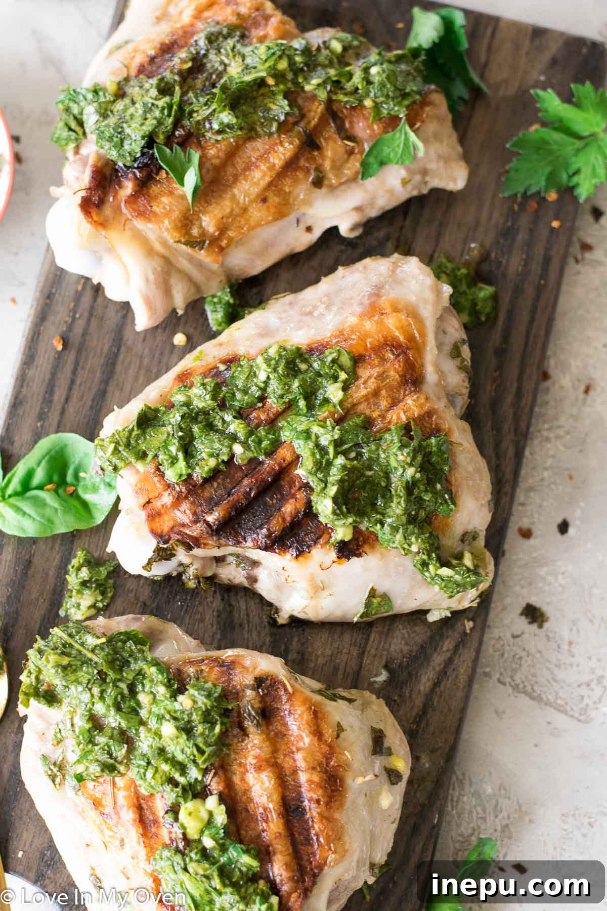 Smoky Turkey Thighs with Vibrant Chimichurri 8 A close-up of a fork cutting into a juicy grilled turkey thigh with chimichurri.