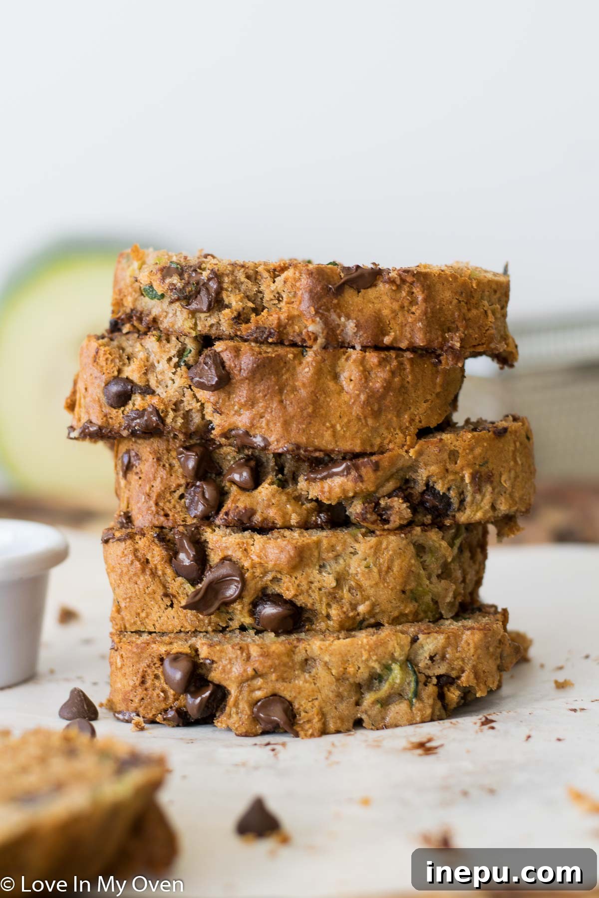 Super moist whole wheat zucchini bread with chocolate chips, sliced and ready to serve